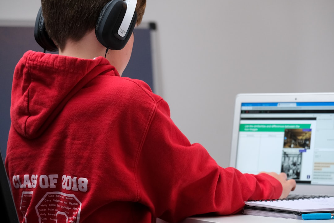 Photo by Compare Fibre boy in red hoodie wearing black headphones